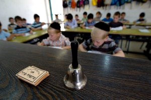 Notes that would be given to outstanding students during the class seen on the teacher's table at the Kehilot Yaacov Torah School for boys in Ramot