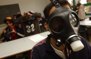 student wears a gas mask during a war exercise