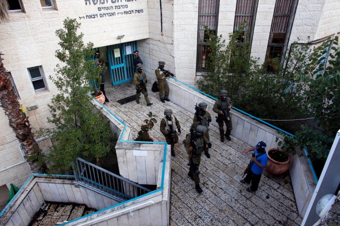 Israeli security personnel  search a religious Jewish Yeshiva next to a synagogue, where a suspected Palestinian attack took place, in Jerusalem,