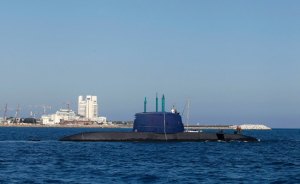 Israeli seamen sit atop Tekumah, a Dolphin-class submarine before a ceremony in Mediterranean Sea near port of Haifa