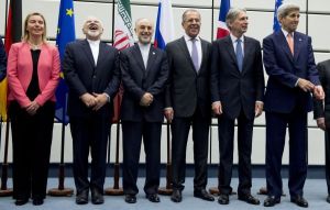From left to right: European Union High Representative Federica Mogherini, Iranian Foreign Minister Mohammad Javad Zarif, Head of the Iranian Atomic Energy Organization Ali Akbar Salehi, Russian Foreign Minister Sergey Lavrov, British Foreign Secretary Philip Hammond and US Secretary of State John Kerry pose for a group picture at the United Nations building in Vienna, Austria, Tuesday, July 14, 2015. After 18 days of intense and often fractious negotiation, diplomats Tuesday declared that world powers and Iran had struck a landmark deal to curb Iran's nuclear program in exchange for billions of dollars in relief from international sanctions, an agreement designed to avert the threat of a nuclear-armed Iran and another U.S. military intervention in the Muslim world. (Joe Klamar/Pool Photo via AP)